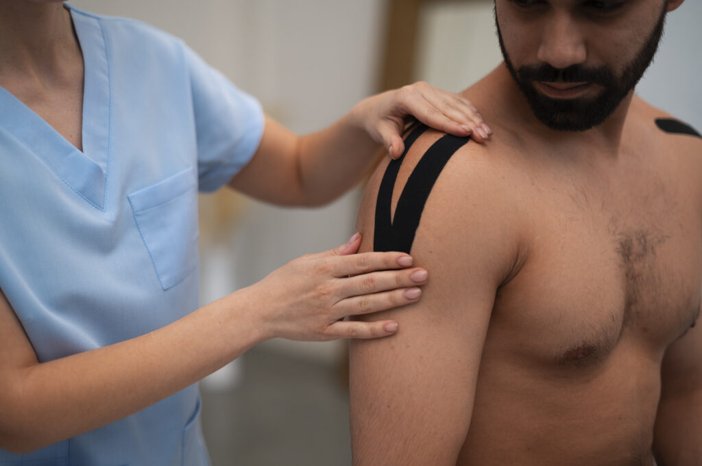 female-therapist-rehabilitation-center-putting-shoulder-support-man